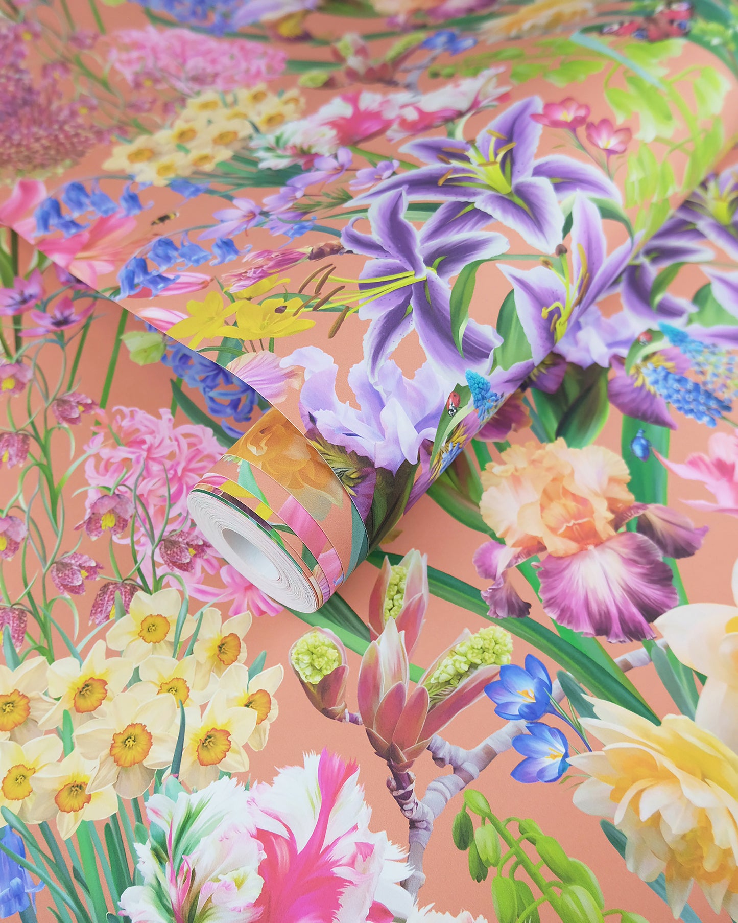 A roll of maximalist designer wall covering in terracotta orange with a spring botanical print for farmhouse interiors