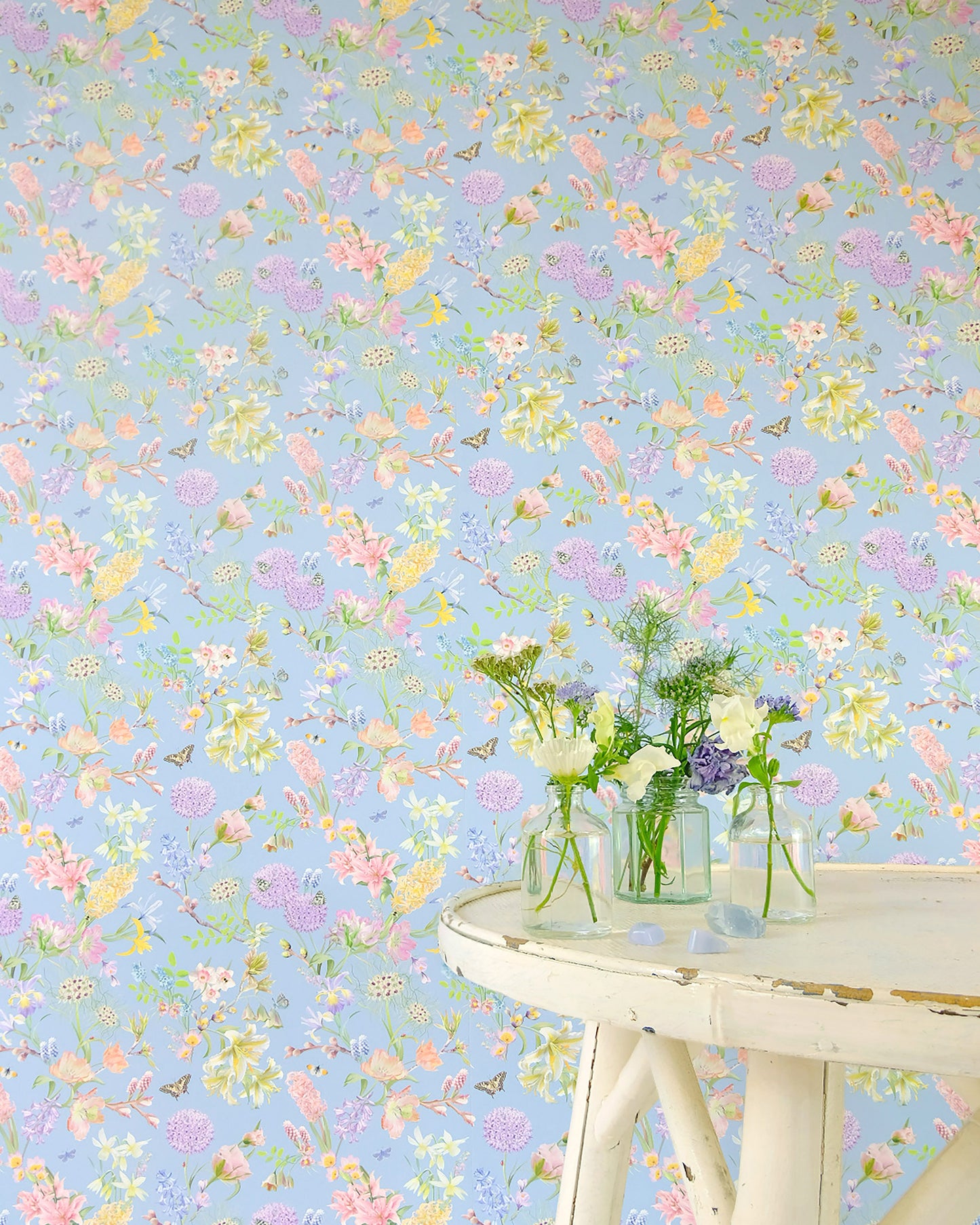 Light blue designer wall covering with a hand illustrated nature inspired design for modern home decor