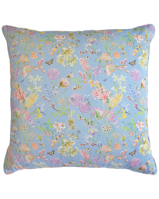 pastel blue organic cotton cushion with a floral pattern and piped embellishment
