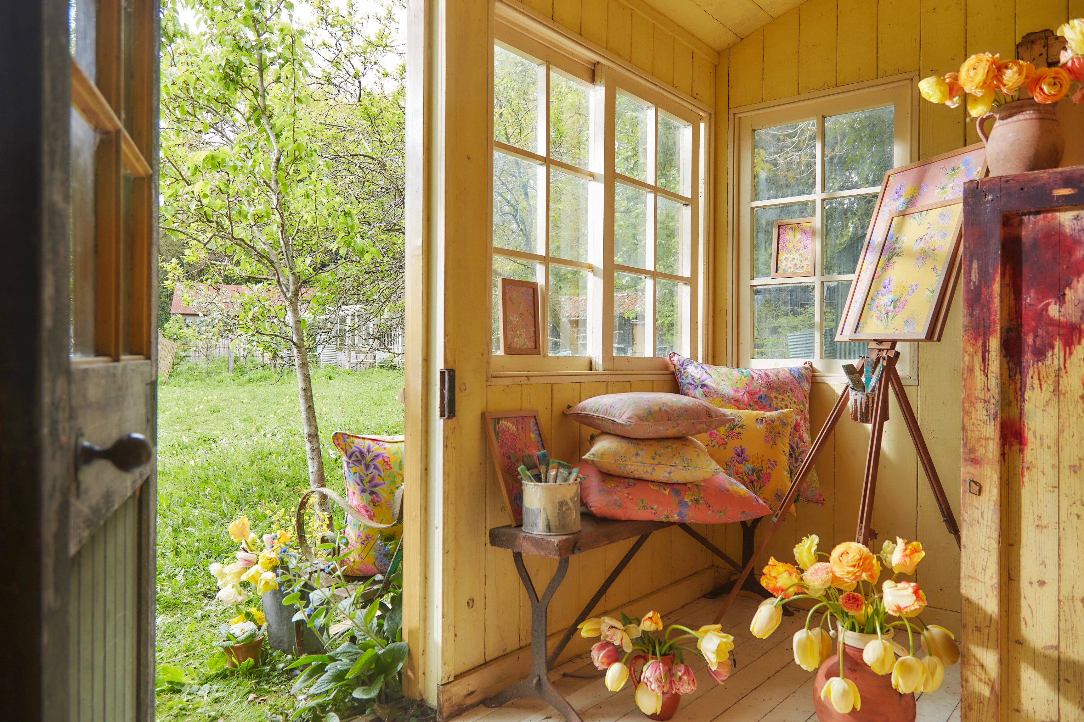 positive spaces created in outside sheds and outbuildings with luxury floral wallpaper, cushions and flower arrangements.