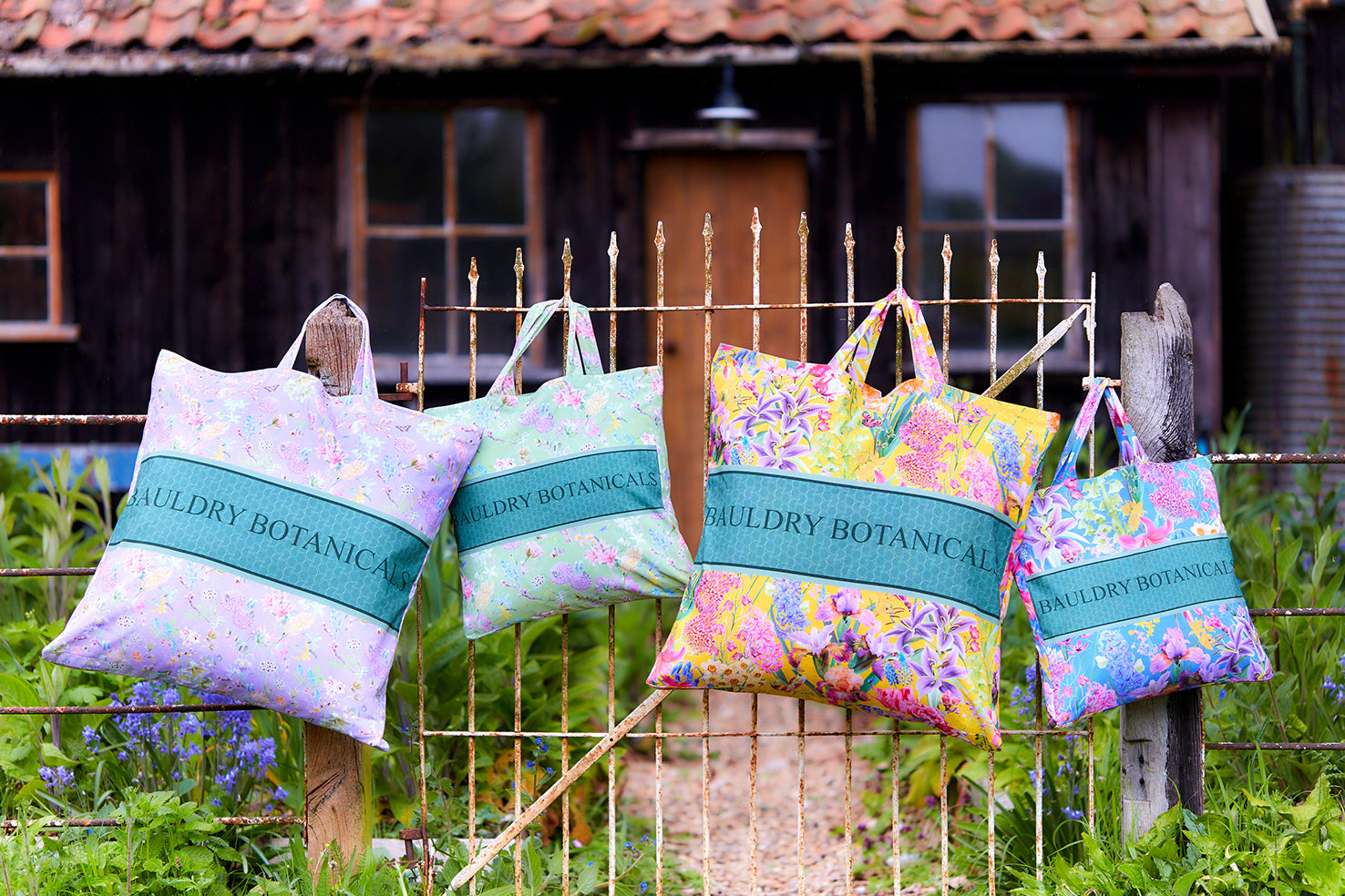 A selection of cotton tote bags with Bauldry Botanicals fabrics and floral patterns in a range of colours