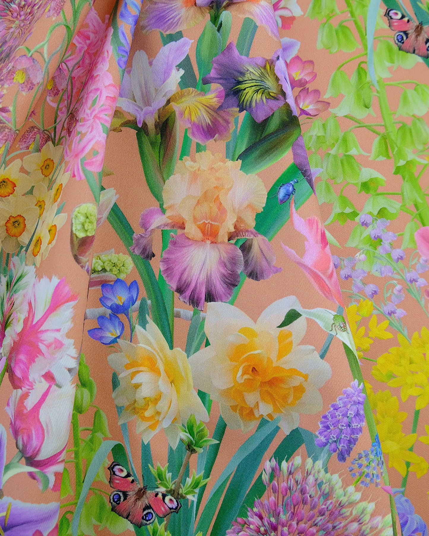 Natural cotton textile in a daffodil, tulip and spring bulb warm peach print for holiday cottages and home renovation.