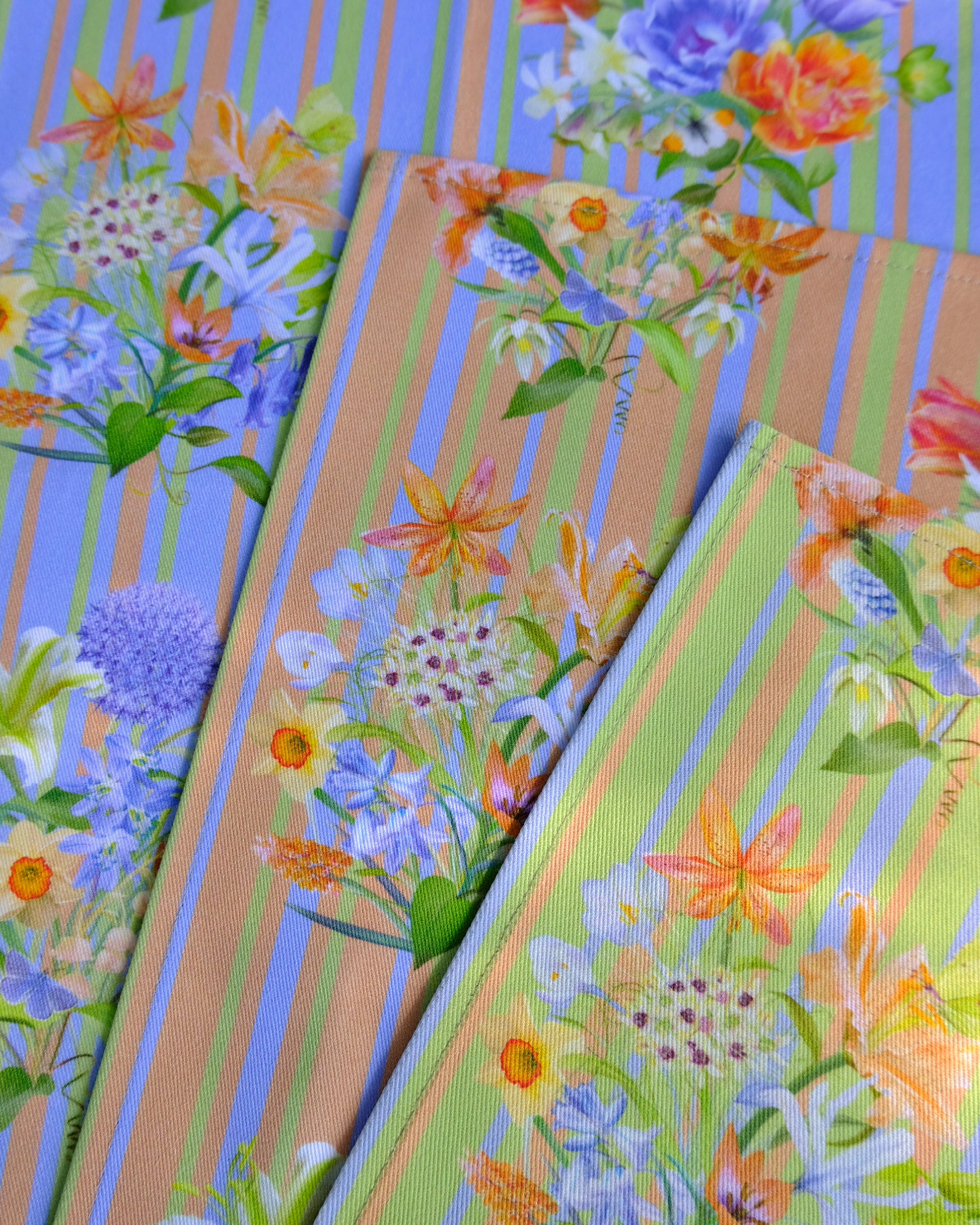 Colourful floral-patterned fabric napkin with blue, green, and orange.