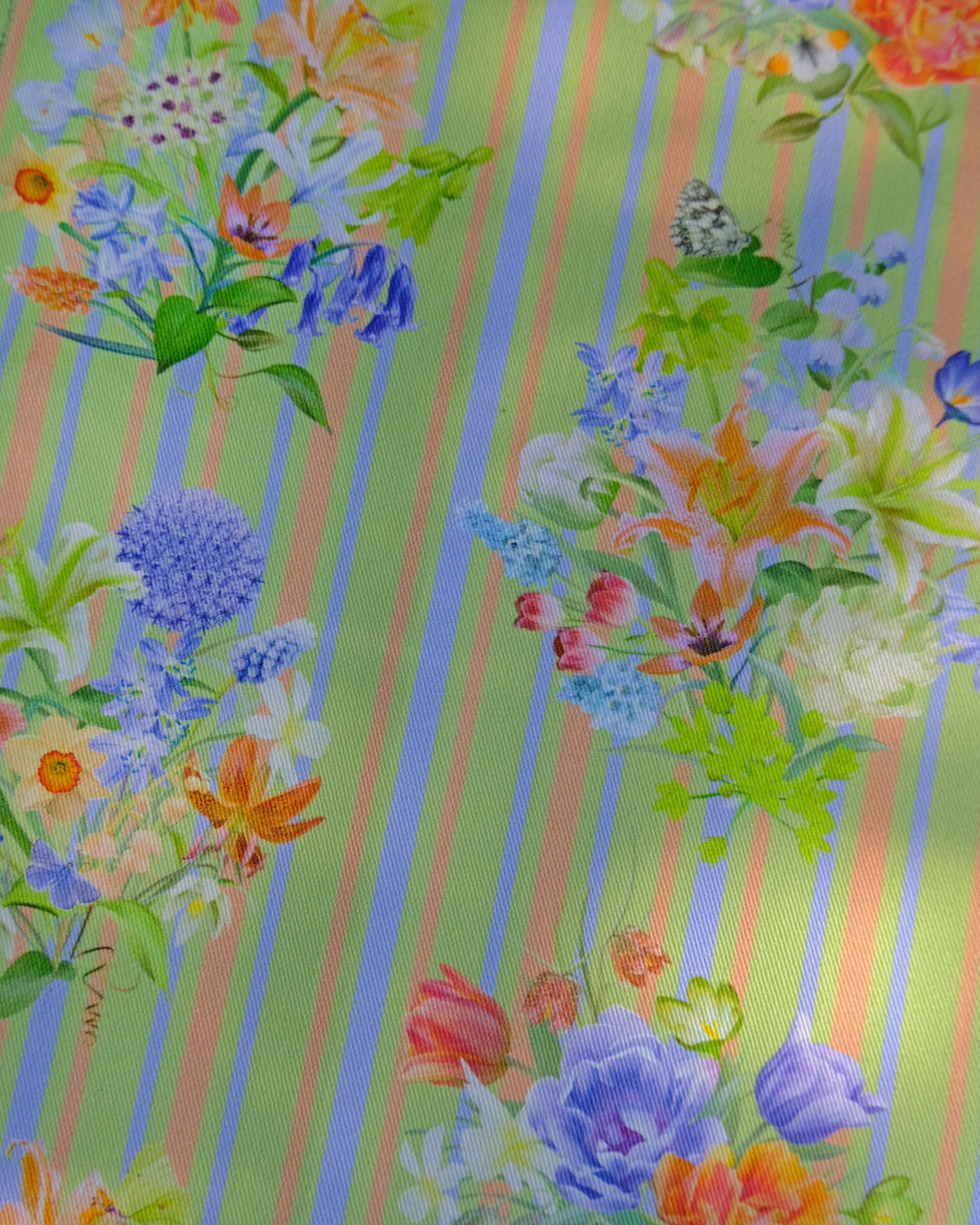 Colourful floral pattern with vertical stripes on a fabric background