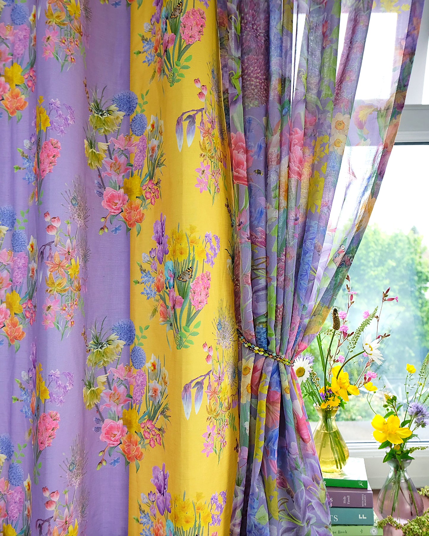 window with purple and yellow sustainable curtains in floral patterns