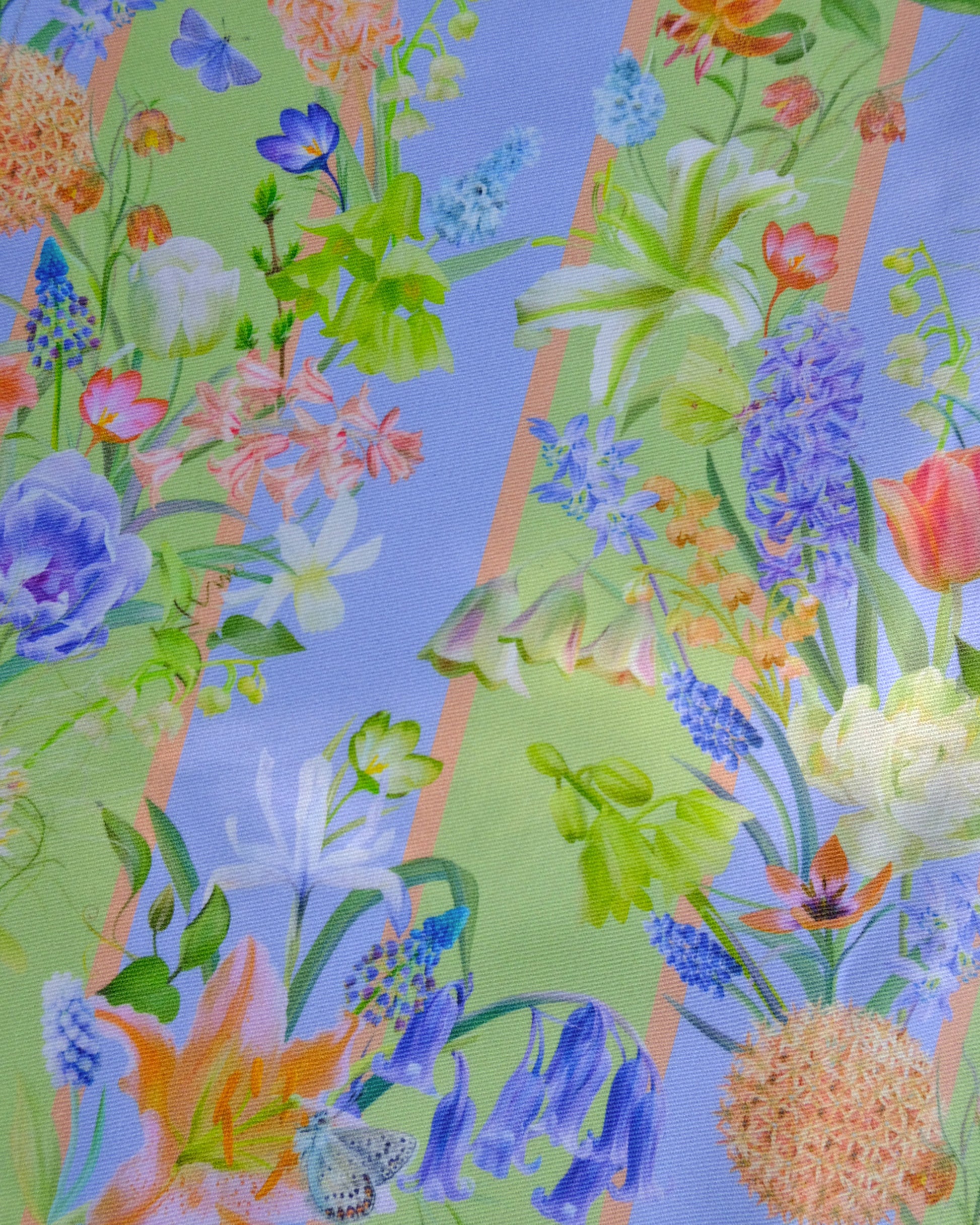 Colourful floral pattern with various flowers and leaves on a blue and green striped background