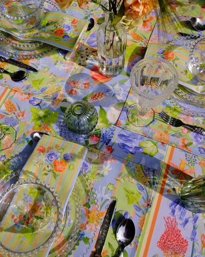 Decorative table setting with a colourful tablecloth and glassware.
