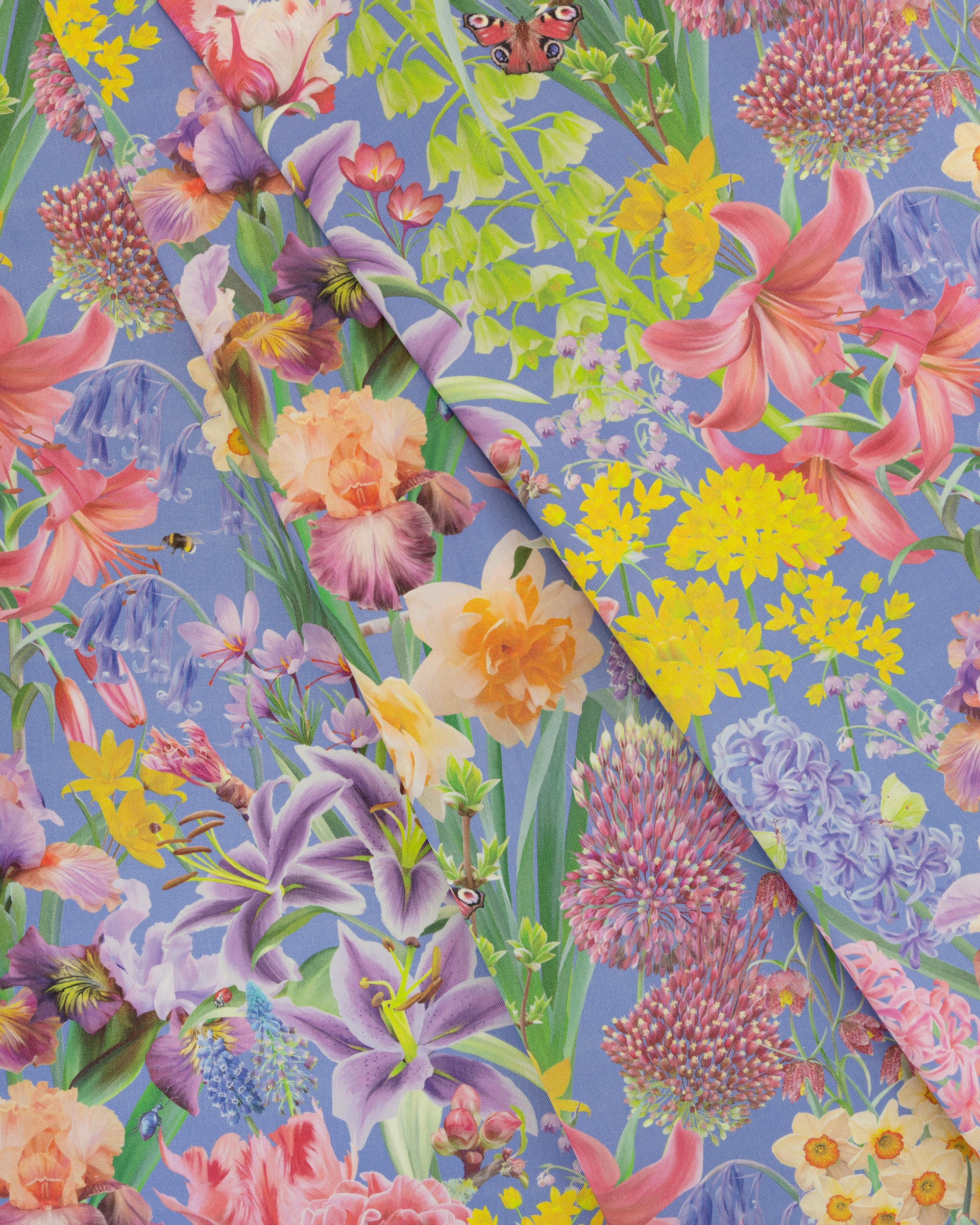 Burst Into Bloom Purple botanical floral fabric featuring hand painted daffodils, crocus and summer flowers in lavender, fuchsia and gold on a bright cobalt background.