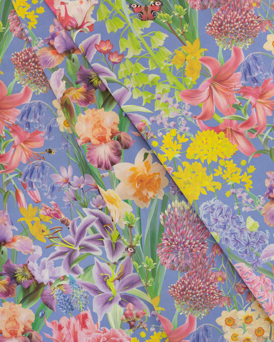 Burst Into Bloom Purple botanical floral fabric featuring hand painted daffodils, crocus and summer flowers in lavender, fuchsia and gold on a bright cobalt background.