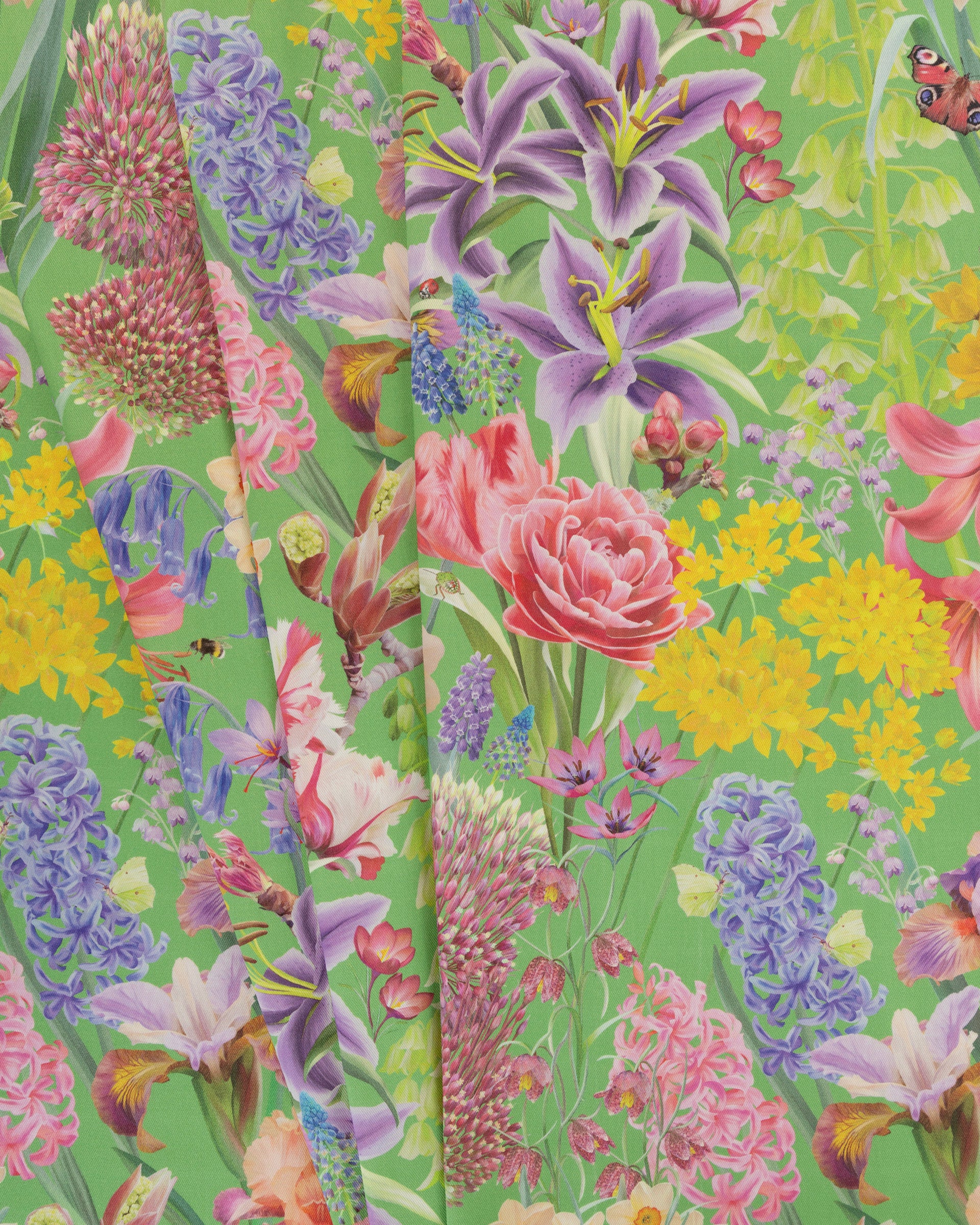 Burst Into Bloom Green botanical floral fabric featuring hand painted bluebells, alliums and summer flowers in lavender, fuchsia and gold on a rich emerald background.