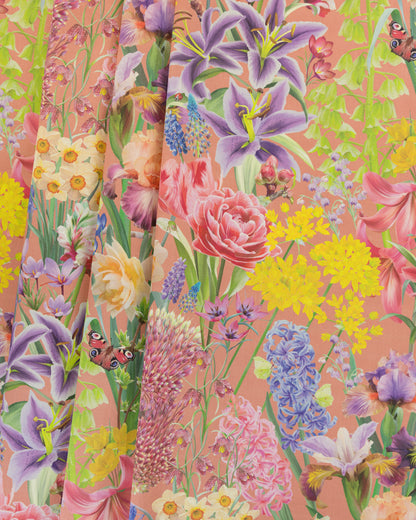 Burst Into Bloom Peach botanical floral fabric featuring hand painted tulips, daffodils and summer flowers in lime green, french blue and rose pink on a warm terracotta background.