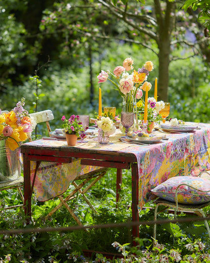Summer inspiring dining setting with designer botanical patterned sustainable fabrics and cushions