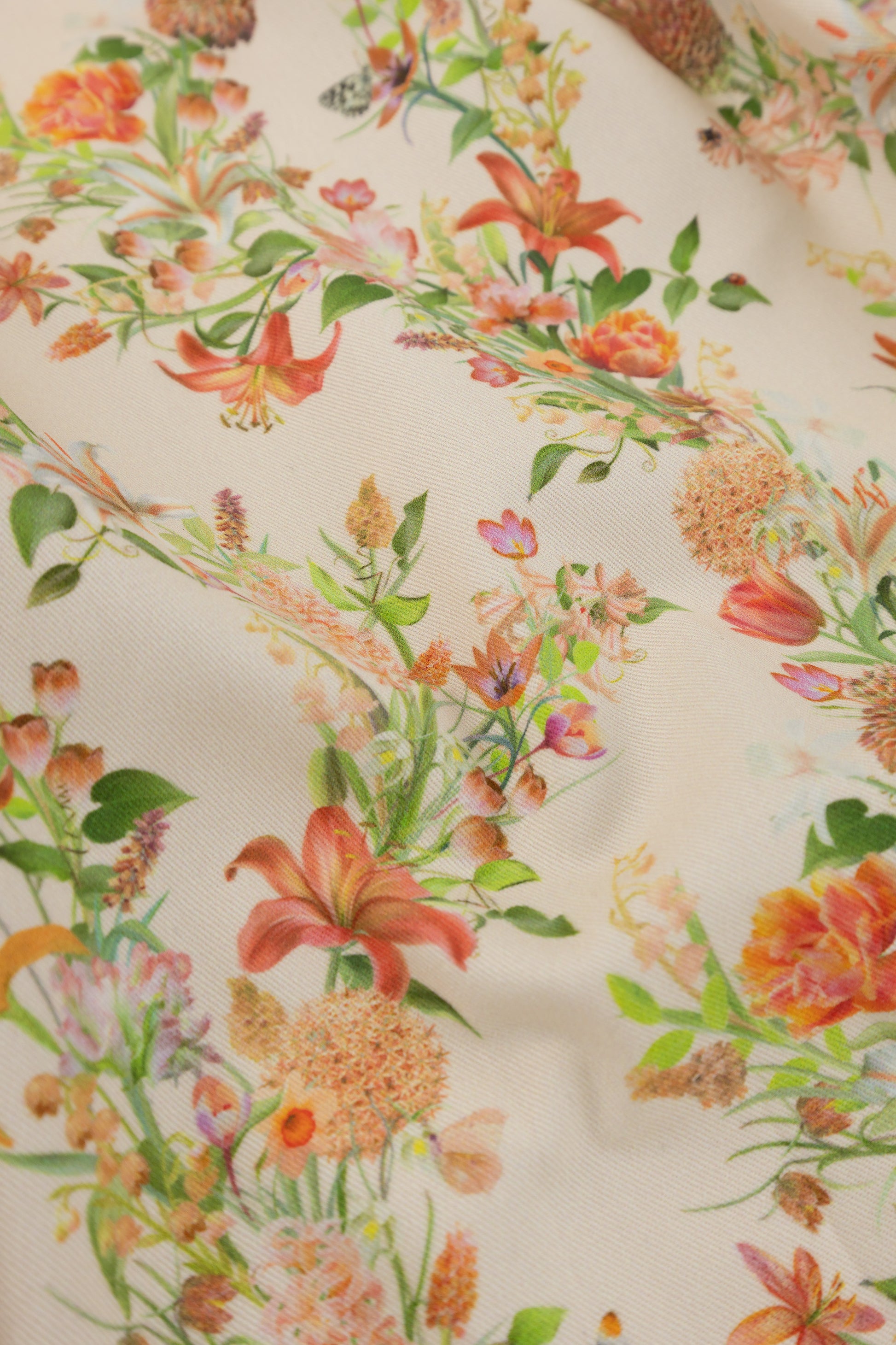 Eternal Drift Veiled Ember orange organic cotton gabardine floral fabric close up showing woven texture detail