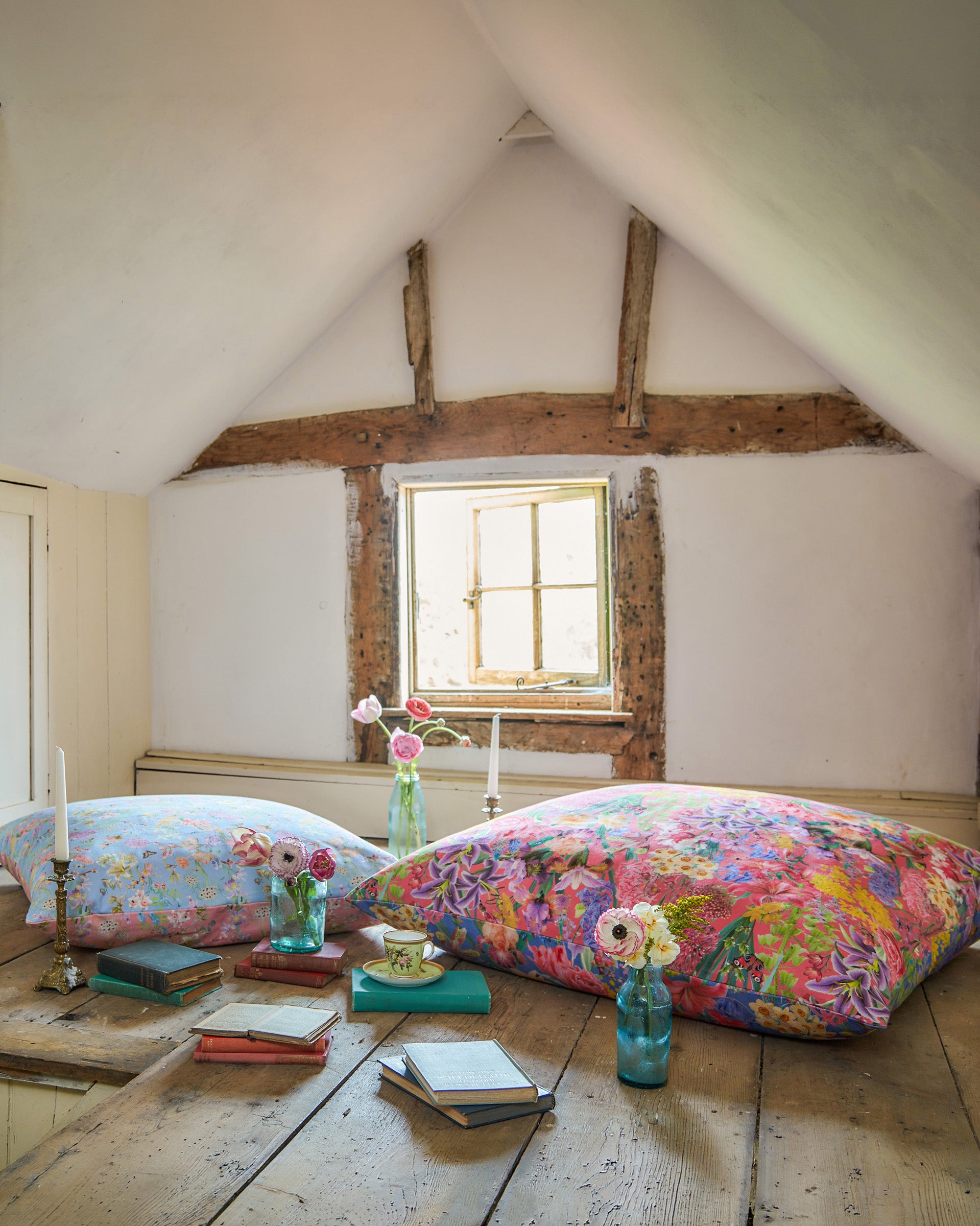 Attic bedroom styled with cushions made from Hopeful Beginnings pale blue botanical fabric, adding soft colour and botanical charm.