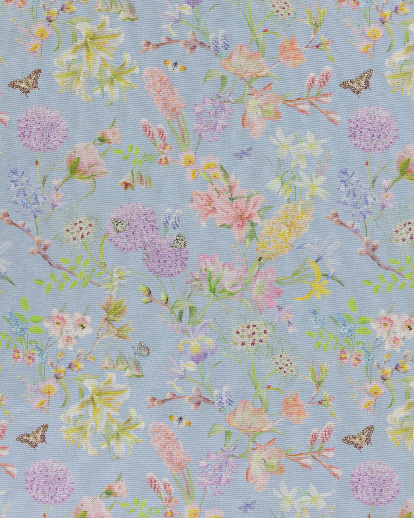 Hopeful Beginnings fabric in blue featuring hand drawn English garden flowers including daffodils, Lillies and iris on a pale blue background.