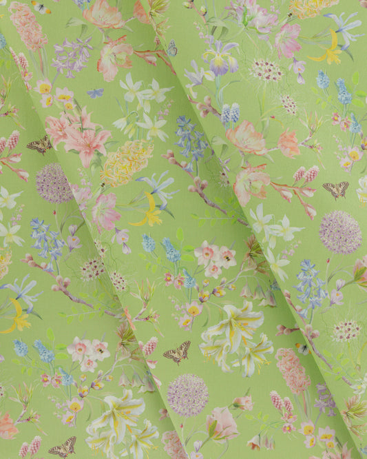 Draped Hopeful Beginnings cotton twill fabric in green showing detailed botanical floral pattern.
