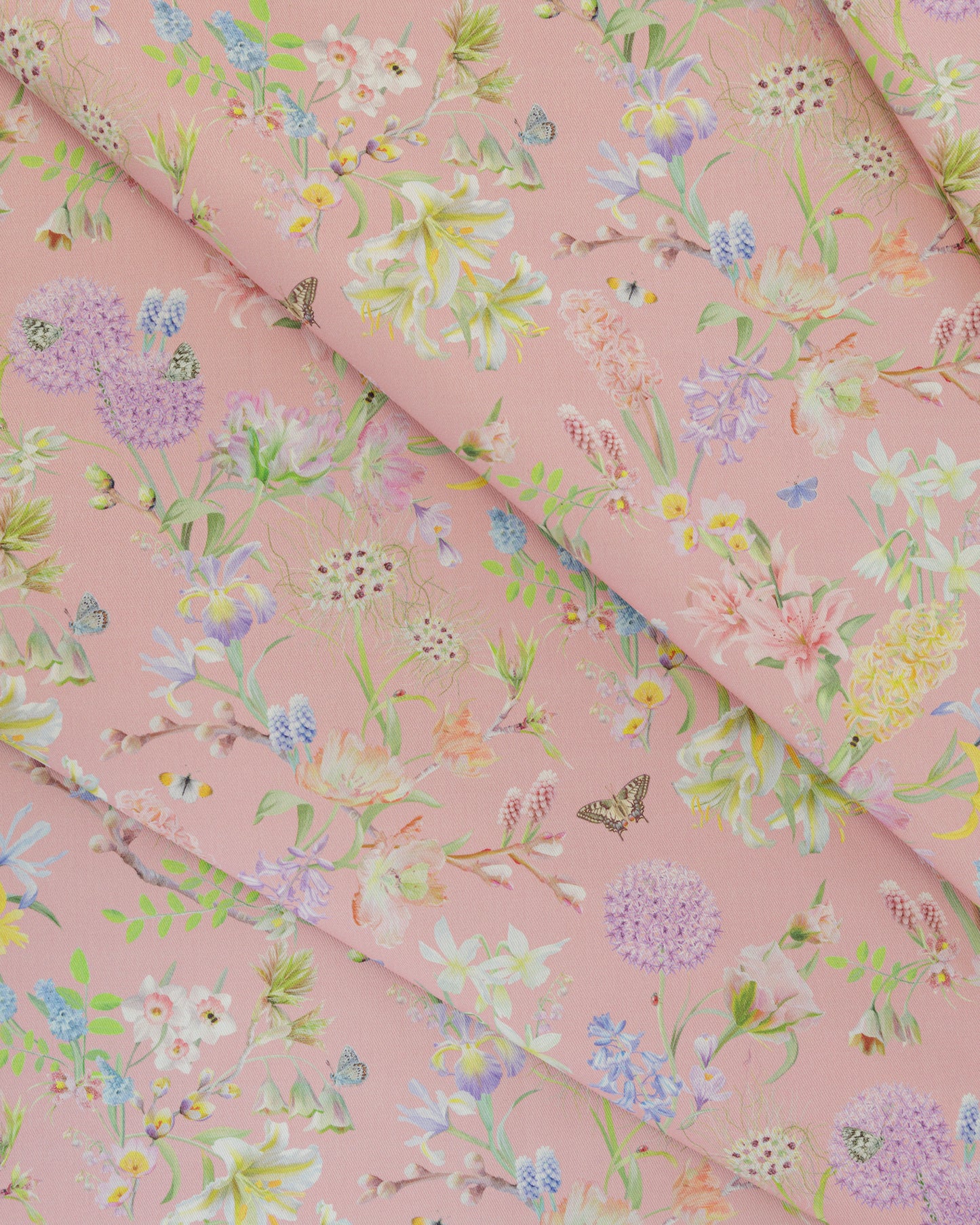 Draped Hopeful Beginnings cotton twill furnishing fabric in pink showing detailed botanical floral pattern.