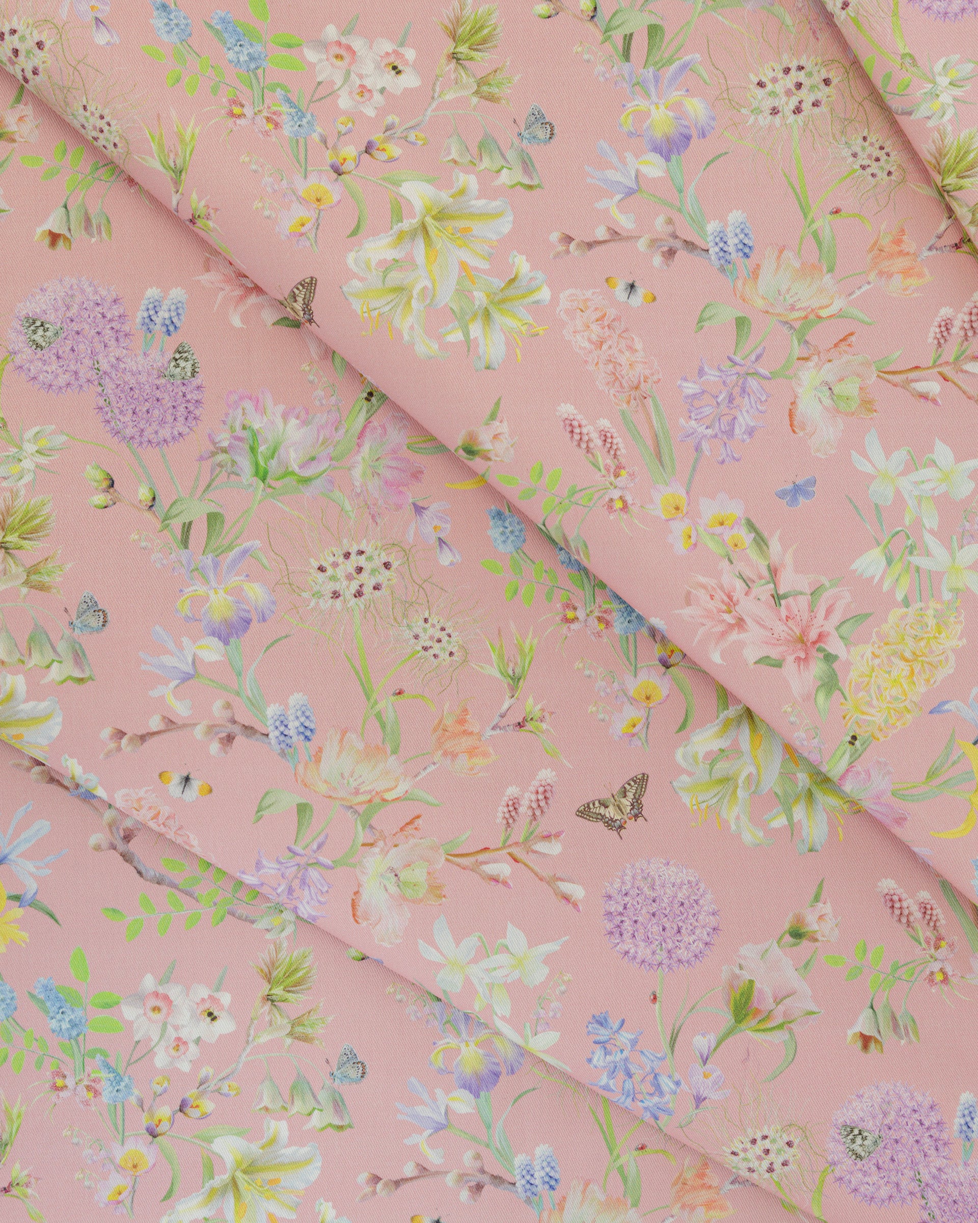 Draped Hopeful Beginnings cotton twill furnishing fabric in pink showing detailed botanical floral pattern.