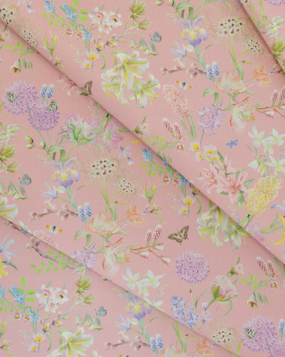 Draped Hopeful Beginnings cotton twill furnishing fabric in pink showing detailed botanical floral pattern.
