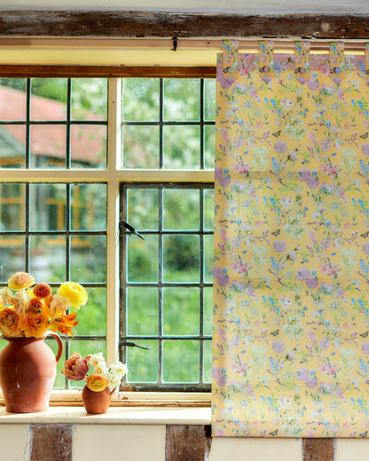 Interior featuring Hopeful Beginnings yellow botanical fabric used for curtains and decorative blinds.