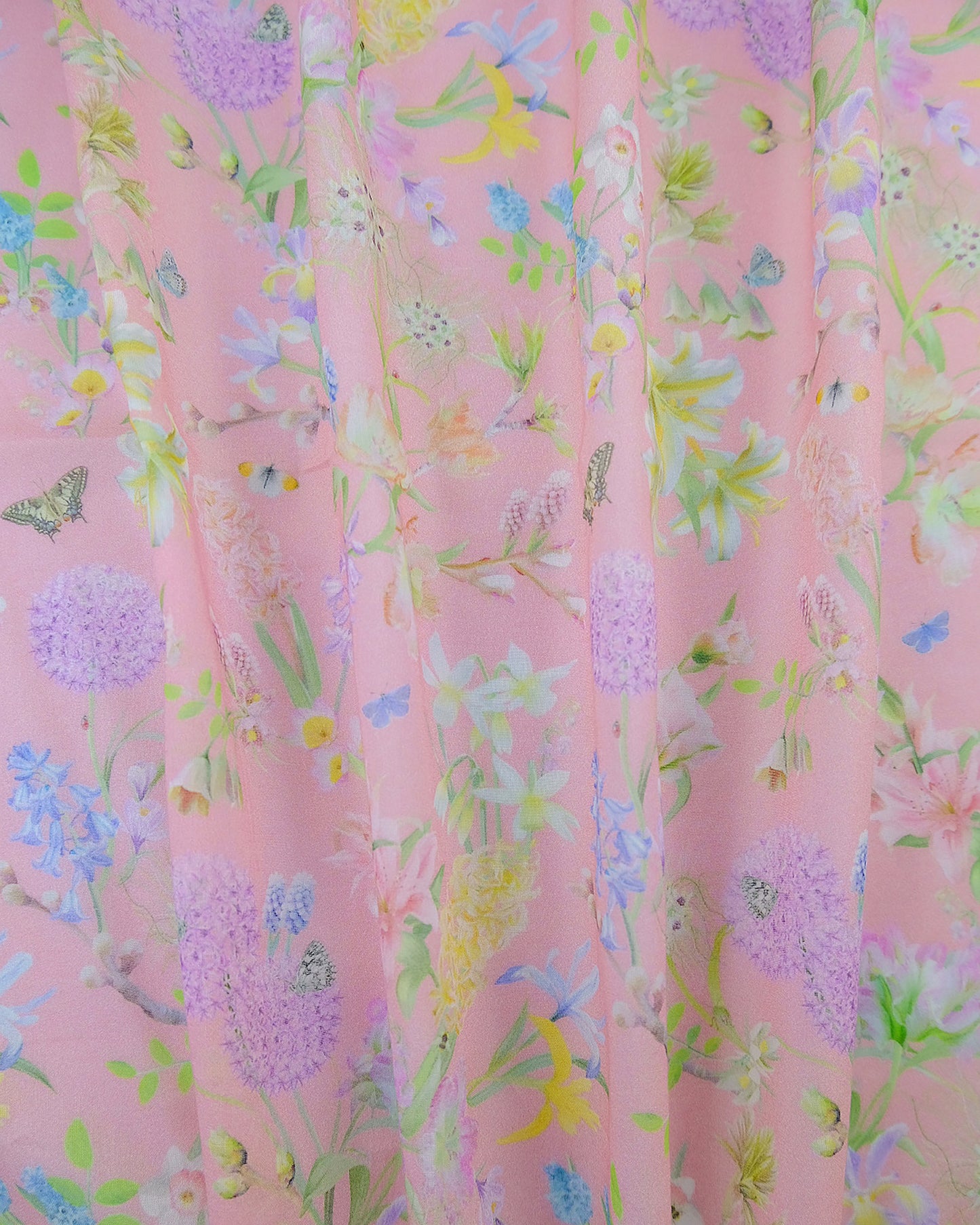 Transparent organic textile in a designer nature inspired baby pink print for window coverings.