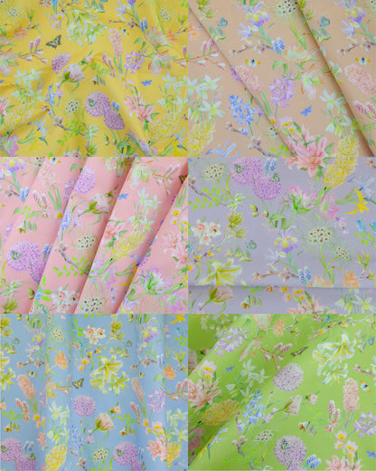 a rainbow of hemp furnishing fabrics in pastel floral botanical designs in yellow, peach, pink, purple, blue and green.