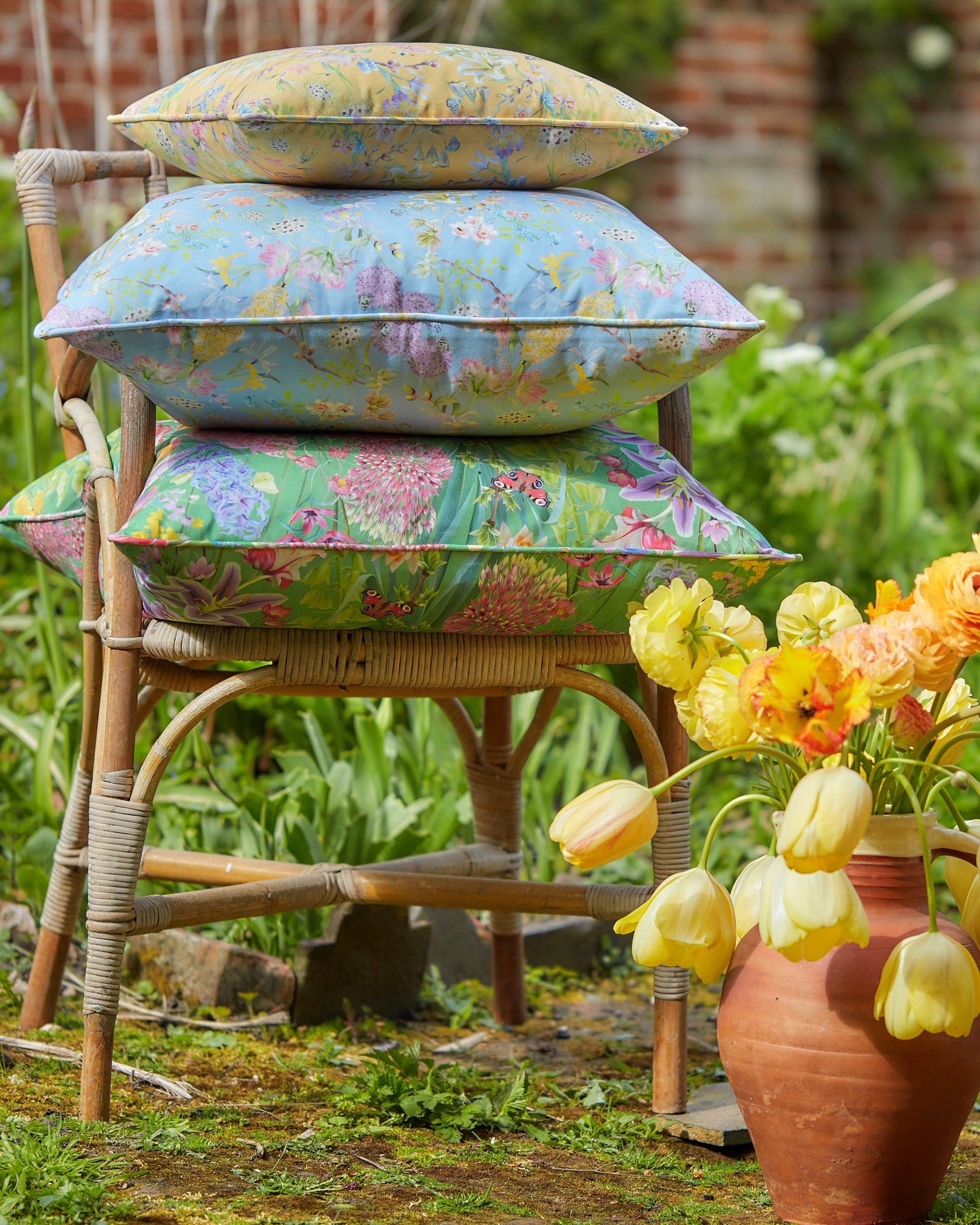 Optimistic interiors filled with yellow blue and green floral designer cushions in sustainable vegan fabrics