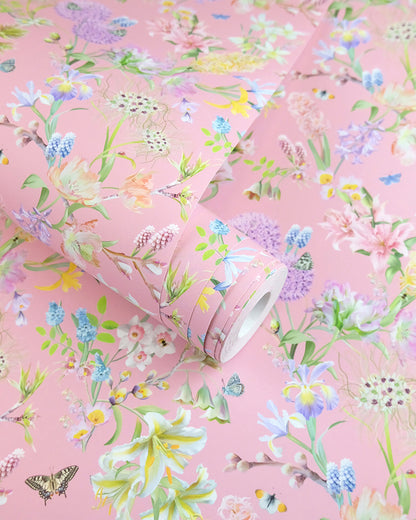 A roll of soft pink neutral wallpaper with a spring botanical print for traditional cottage interior design