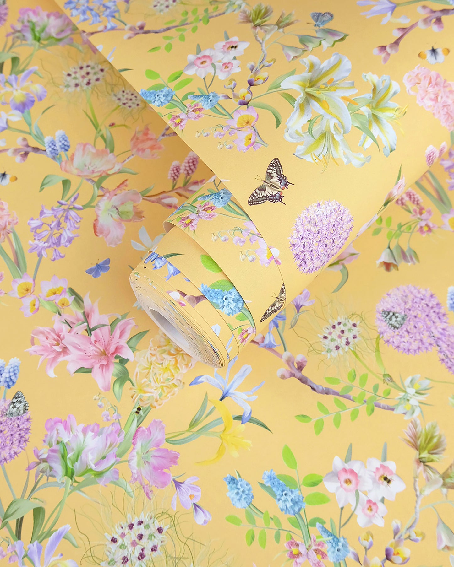 A roll of soft butter yellow neutral wallpaper with a spring botanical print for traditional cottage interior design