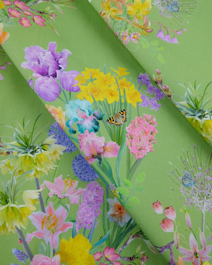 Uplifting conscious material in a bright flowering lush green design for modern soft furnishings and window coverings