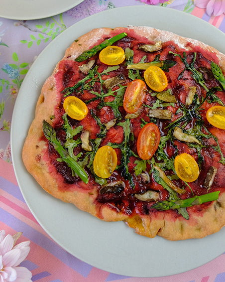 pink beetroot handmade pizza base with home grown organic vegetables