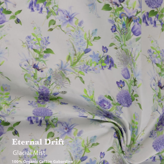 Eternal Drift Glacial Mist blue gabardine fabric in 100% organic cotton, shown draped as curtains with soft flowing movement and natural weave.