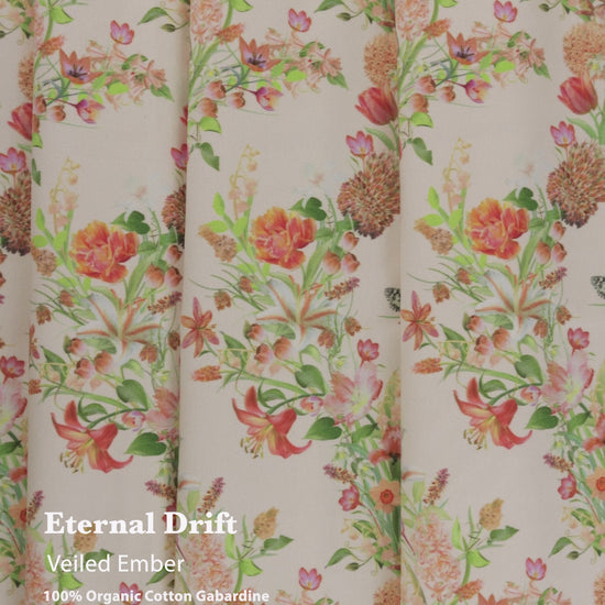 Eternal Drift Veiled Ember orange gabardine fabric in 100% organic cotton, shown draped as curtains with soft flowing movement and natural weave.