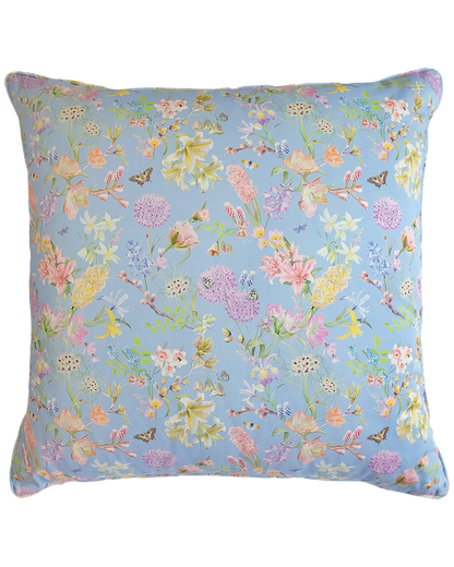 pastel blue organic cotton cushion with a floral pattern and piped embellishment 
